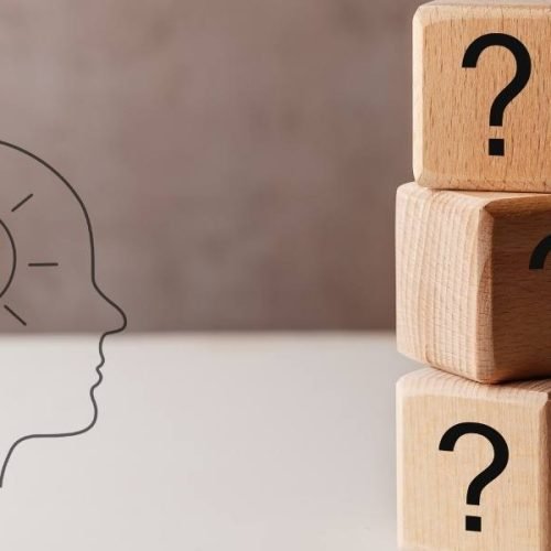 Wooden question blocks and illuminated mind illustration for overcoming the feeling of being behind in life.